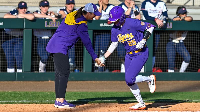 LSU first baseman Georgia Clark (25) celebrates with head coach Beth Torina after hitting a...